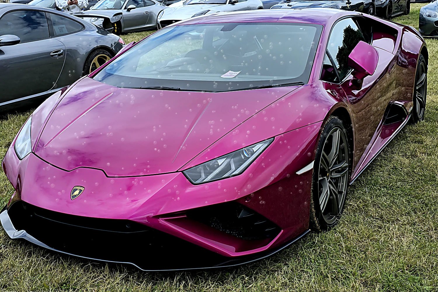 The same car with paint protection film, water beading on the panels